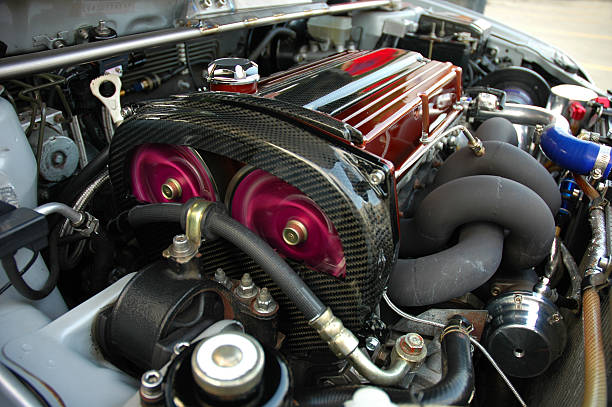 A modified motor running under the hood of a sports car.